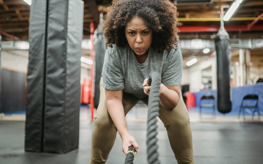 A determined woman with a strong mindset lifting weights to achieve her fitness goals.